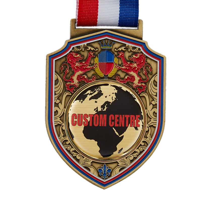 50mm centre gold regal medal design with red lion details, a blue shield and crown with other ornate detailing. Red, blue and white ribbon. The centre circle is showing you where to place your custom artwork.