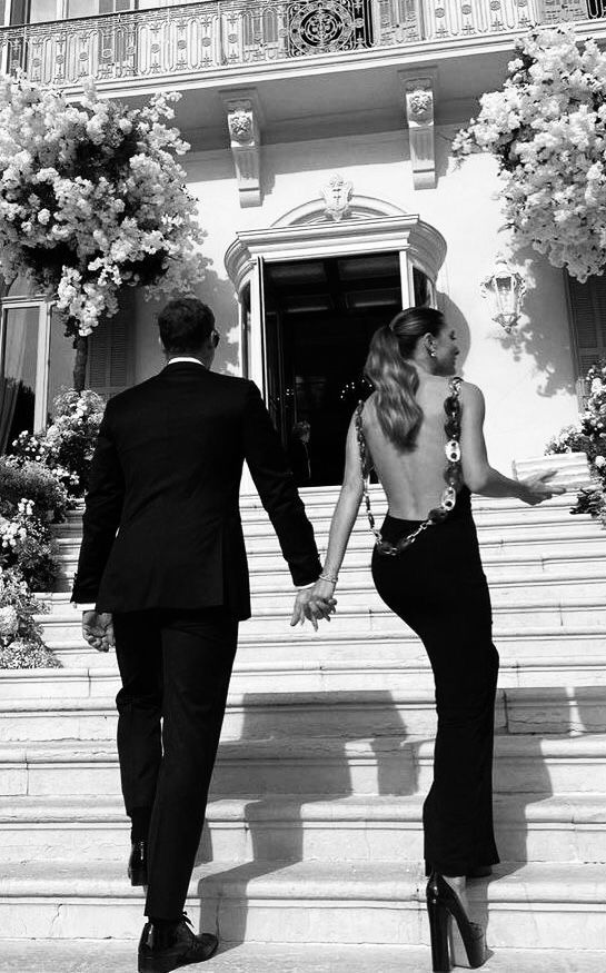 Couple holding hands, walking up the stairs.