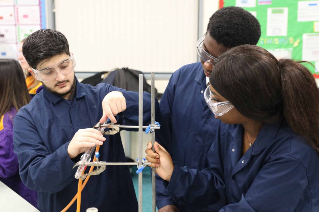 Young students conducting an experiment at Walsall Academy Secondary School.