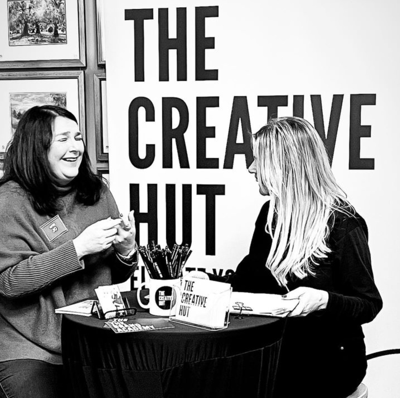 the boss of the creative hut speaking to a client at a works event 