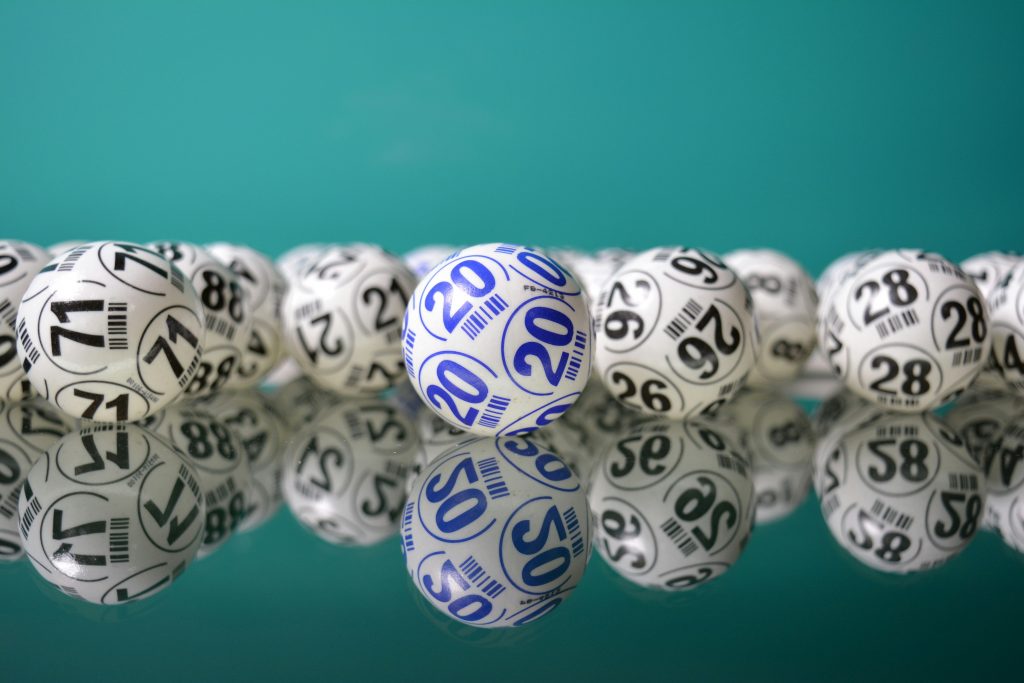 Bingo Balls with numbers on them on a blue background. 