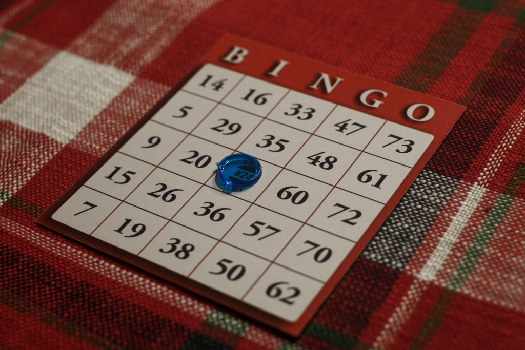 A bingo card with a small blue button on number 24.